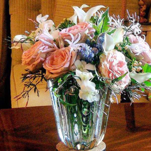Pink and white flower arrangement in a clear glass vase