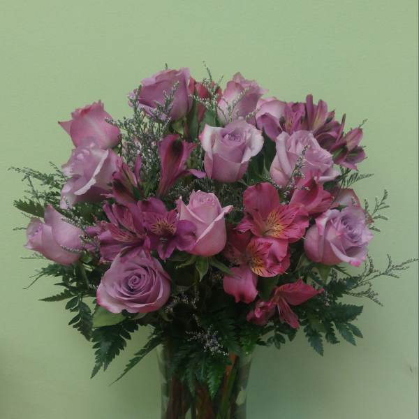 Pink roses and alstroemeria in a clear glass vase