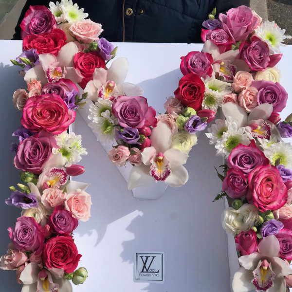 Floral letter arrangement with pink and white roses and orchids