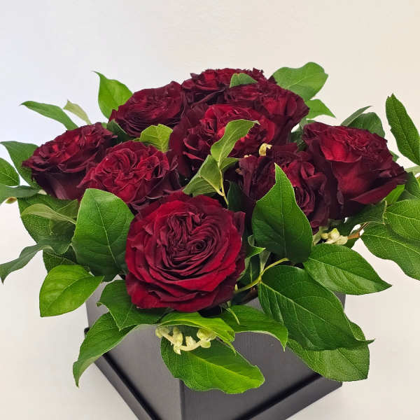 Beautiful arrangement of roses in a black box