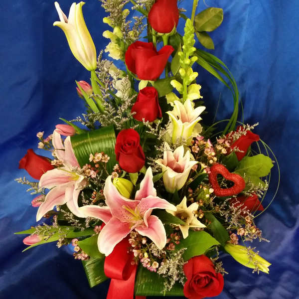 basket with red roses and lilies