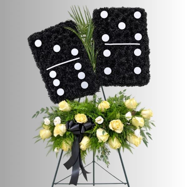 Black floral standing tribute with yellow and white roses on an easel