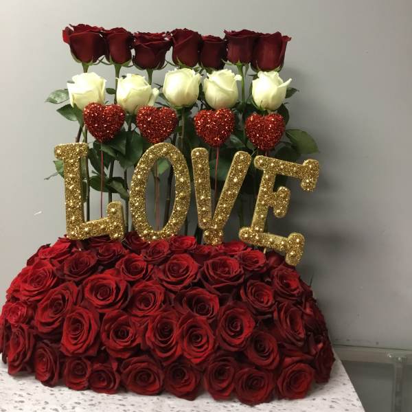 Heart-shaped rose arrangement with gold glitter "LOVE" letters