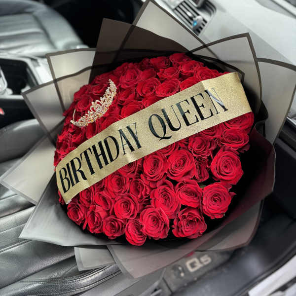 Bouquet of red roses with a birthday sash and tiara