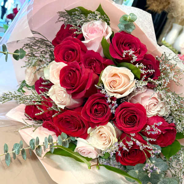 Bouquet of red and blush roses with eucalyptus and filler flowers