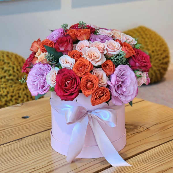Pink hatbox arrangement of roses with a satin ribbon