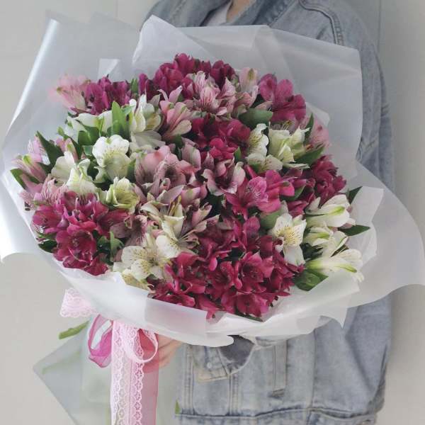 Bouquet of pink, white, and magenta alstroemeria wrapped in white paper
