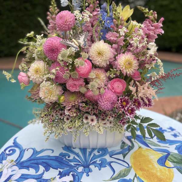 Mixed pastel flower arrangement in a white bowl vase