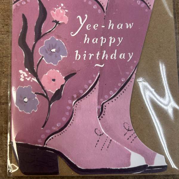 Pink cowboy boot birthday card with floral designs and 'Yee-haw happy birthday' text