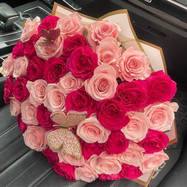 Bouquet of pink and hot pink roses with butterfly picks