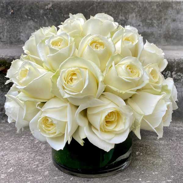 White rose bouquet in a dark glass vase