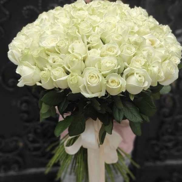 Round bouquet of white roses with a pale ribbon wrap