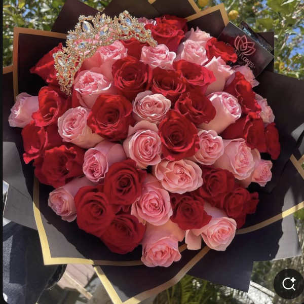 Bouquet of red and pink roses with a jeweled crown topper
