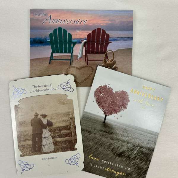 Three anniversary greeting cards with beach and heart designs