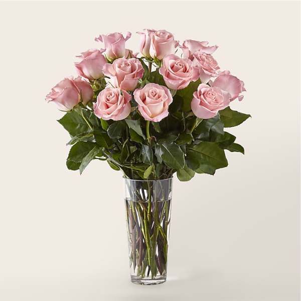 Pink roses arranged in a clear glass vase