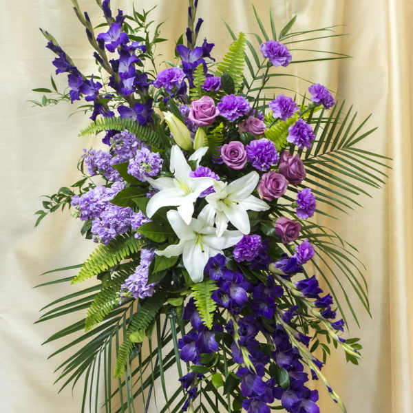 Purple and white floral standing spray with lilies and roses
