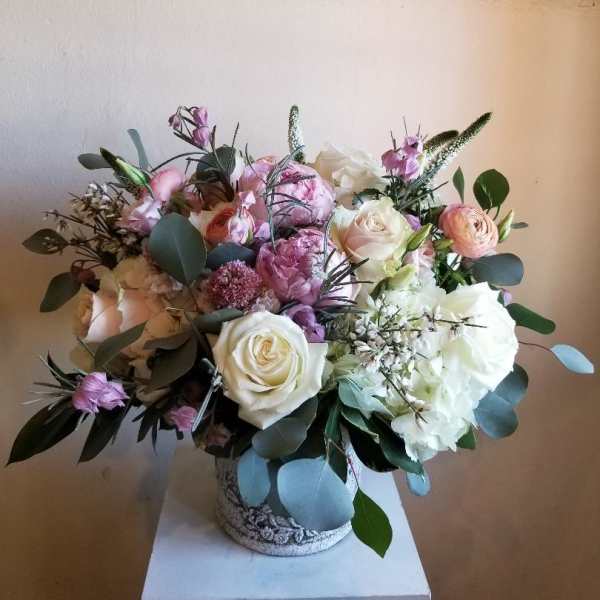 Bouquet of white, pink, and peach flowers in a decorative vase