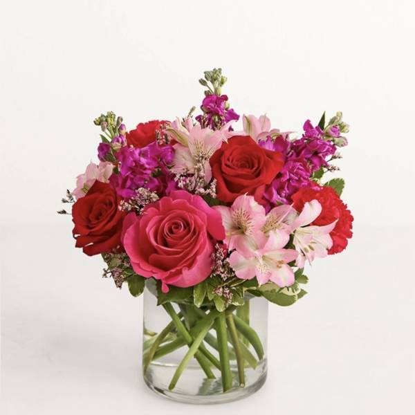 Pink and red rose bouquet in a clear glass vase