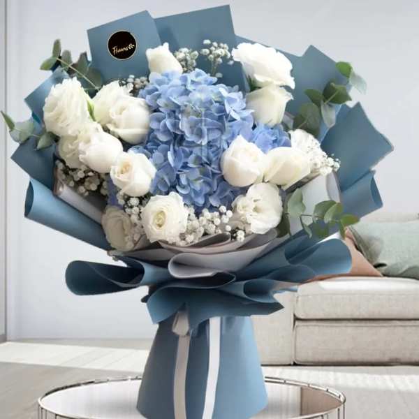 Blue and white bouquet with roses and hydrangea wrapped in blue paper