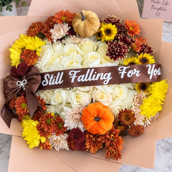 Bouquet of white roses and colorful chrysanthemums with a brown ribbon