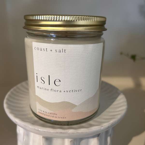 Soy wax candle in a glass jar with a gold lid