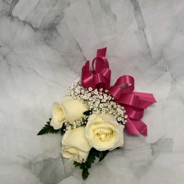 Cream roses with baby's breath and a pink ribbon bow
