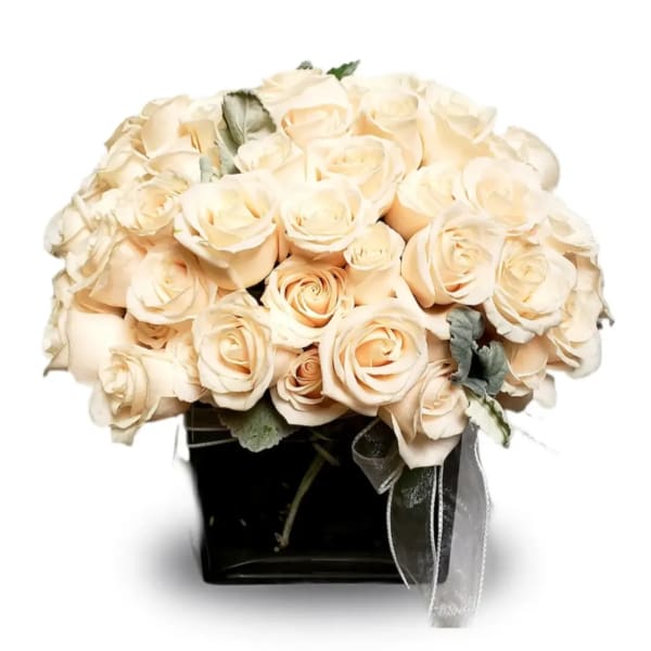 Cream rose bouquet in a black square vase with ribbon