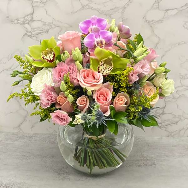 Pink and white mixed bouquet in a round glass vase