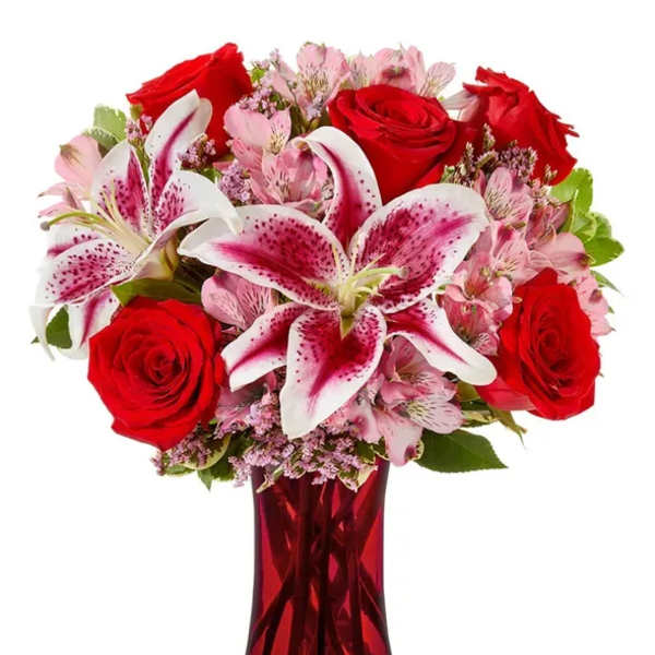 Red roses and pink lilies in a red glass vase