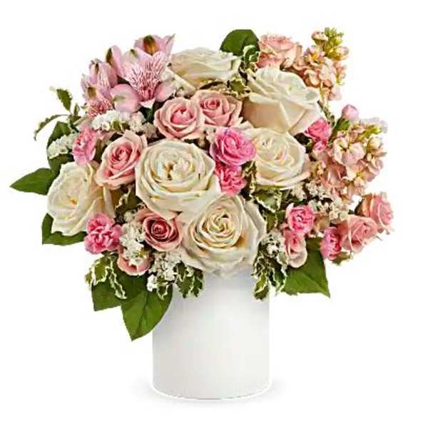 Pink and white rose bouquet in a white cylindrical vase