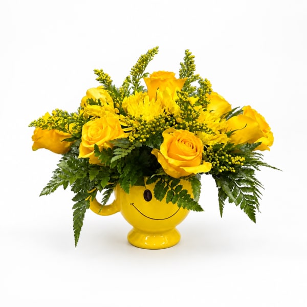 Yellow roses and mums in a smiley-face mug