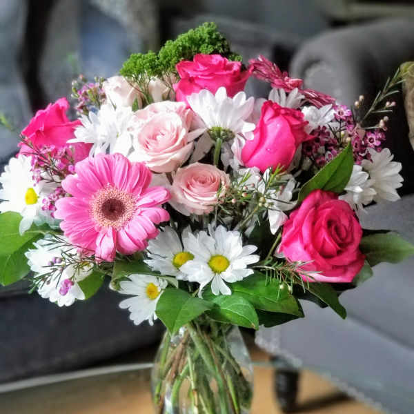 Pink and white mixed flower bouquet in a glass vase