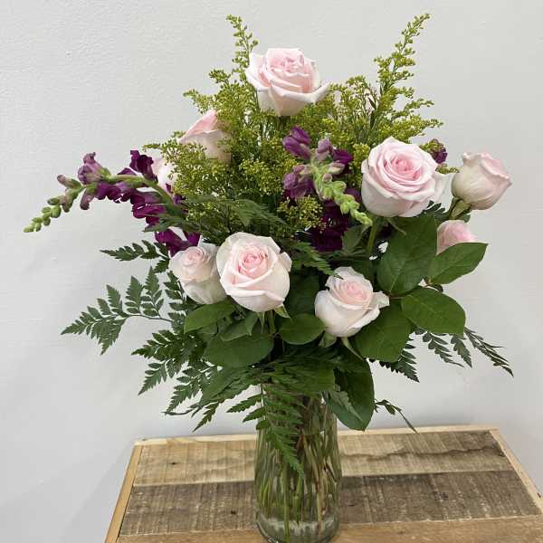 Pink roses and purple snapdragons in a glass vase