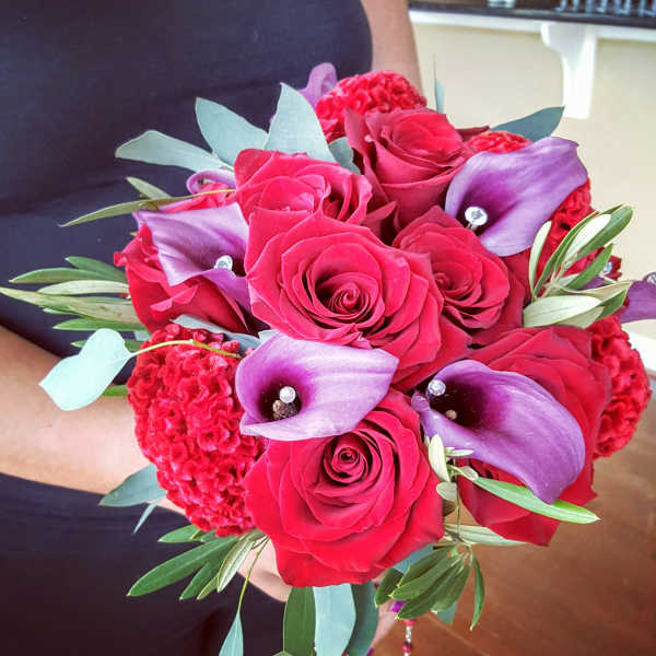 Bouquet of red roses and purple calla lilies