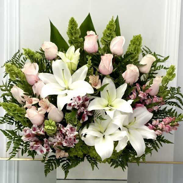 Bouquet of white lilies, pale pink roses, and pink alstroemeria