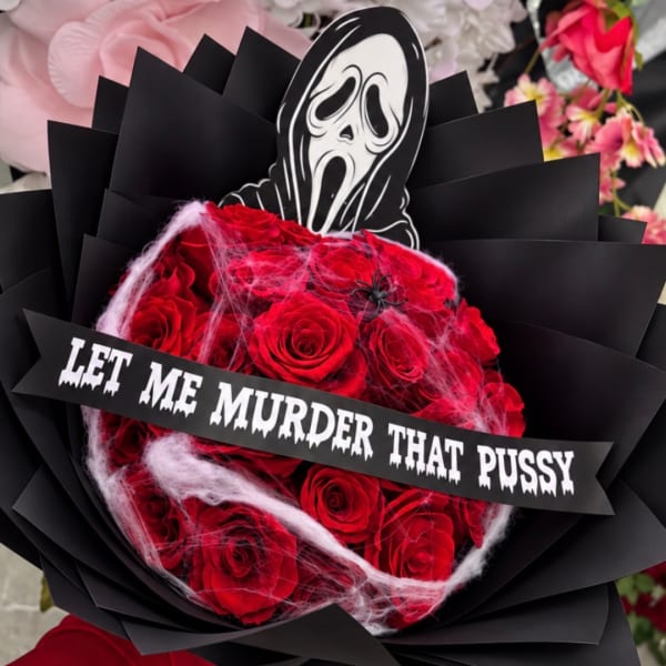 Red rose bouquet with a horror mask topper and a text banner