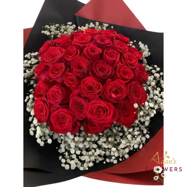 Bouquet of red roses with white baby's breath in black and red wrap