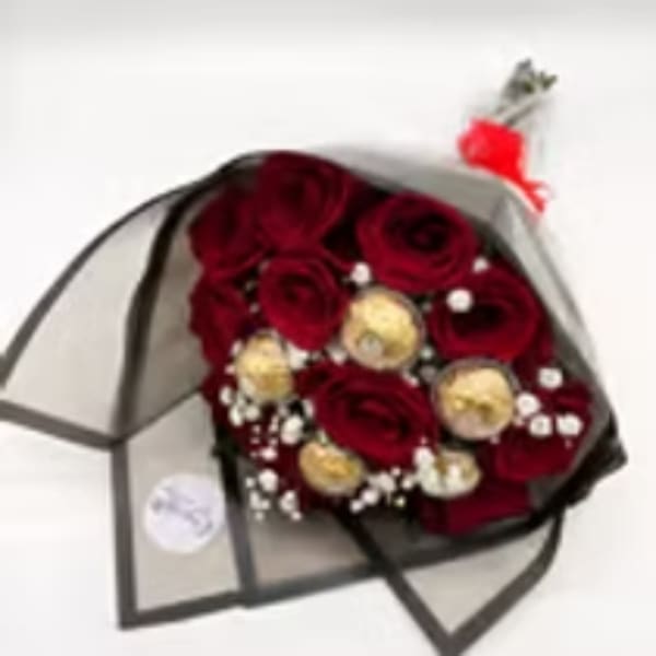 Bouquet of red roses with gold accents wrapped in black paper