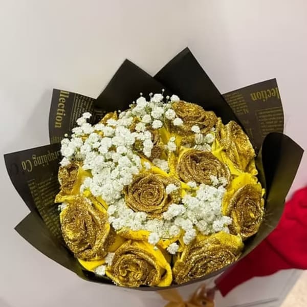 Bouquet of gold roses with white baby's breath in black wrapping