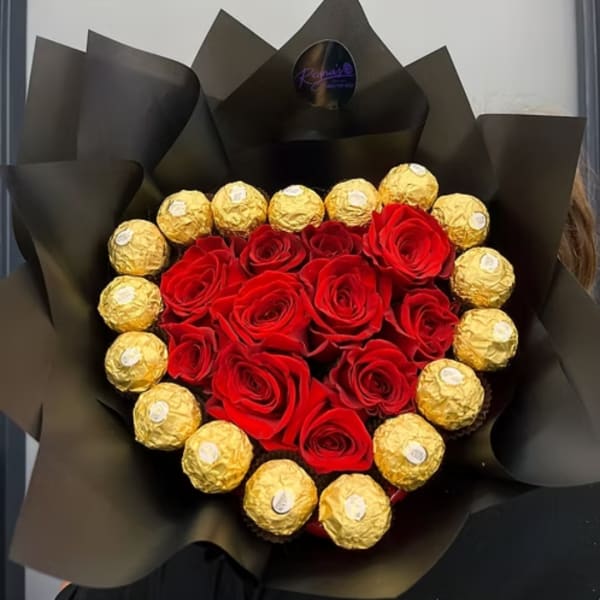 Heart-shaped bouquet of red roses and gold-wrapped chocolates in black paper