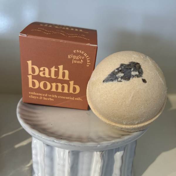 Bath bomb and boxed bath product on a small ceramic pedestal