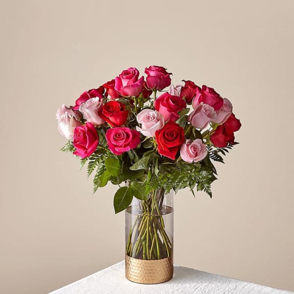 Bouquet of pink and red roses in a clear glass vase