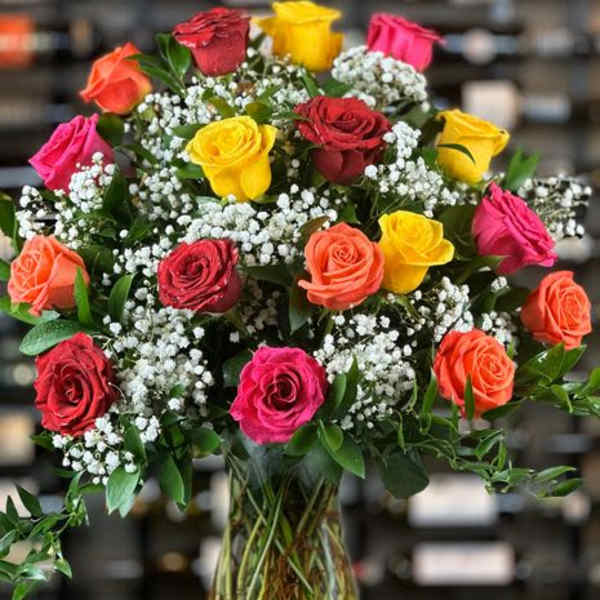 Mixed roses in a glass vase with baby's breath