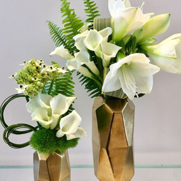 White calla lily arrangements in gold geometric vases
