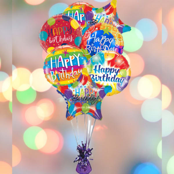 Cluster of colorful Happy Birthday balloons tied together