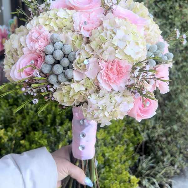 Pink roses and hydrangeas in a hand-tied bouquet