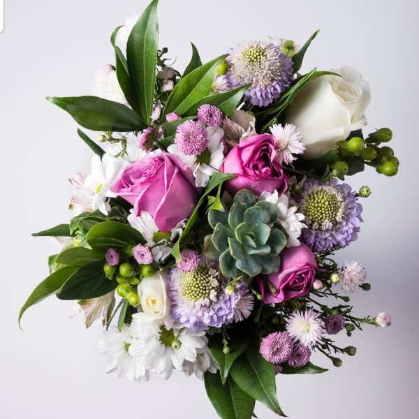 Bouquet of pink and white roses with purple blooms and a succulent