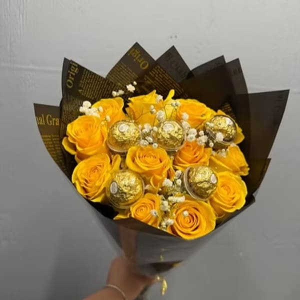 Yellow rose bouquet with gold-wrapped chocolates and white filler flowers