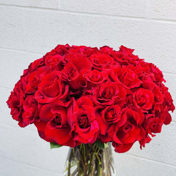 Large bouquet of red roses in a clear glass vase