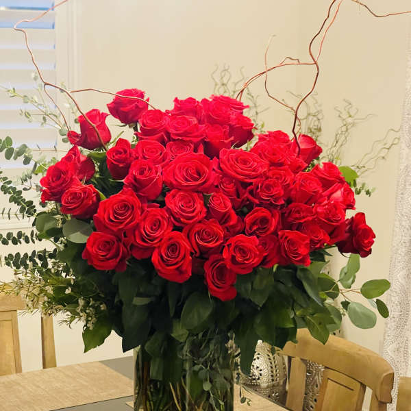Large bouquet of red roses in a clear glass vase